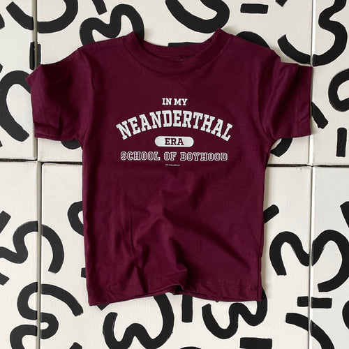 Maroon kid shirt with white graphic text that reads In My Neanderthal Era School of Boyhood